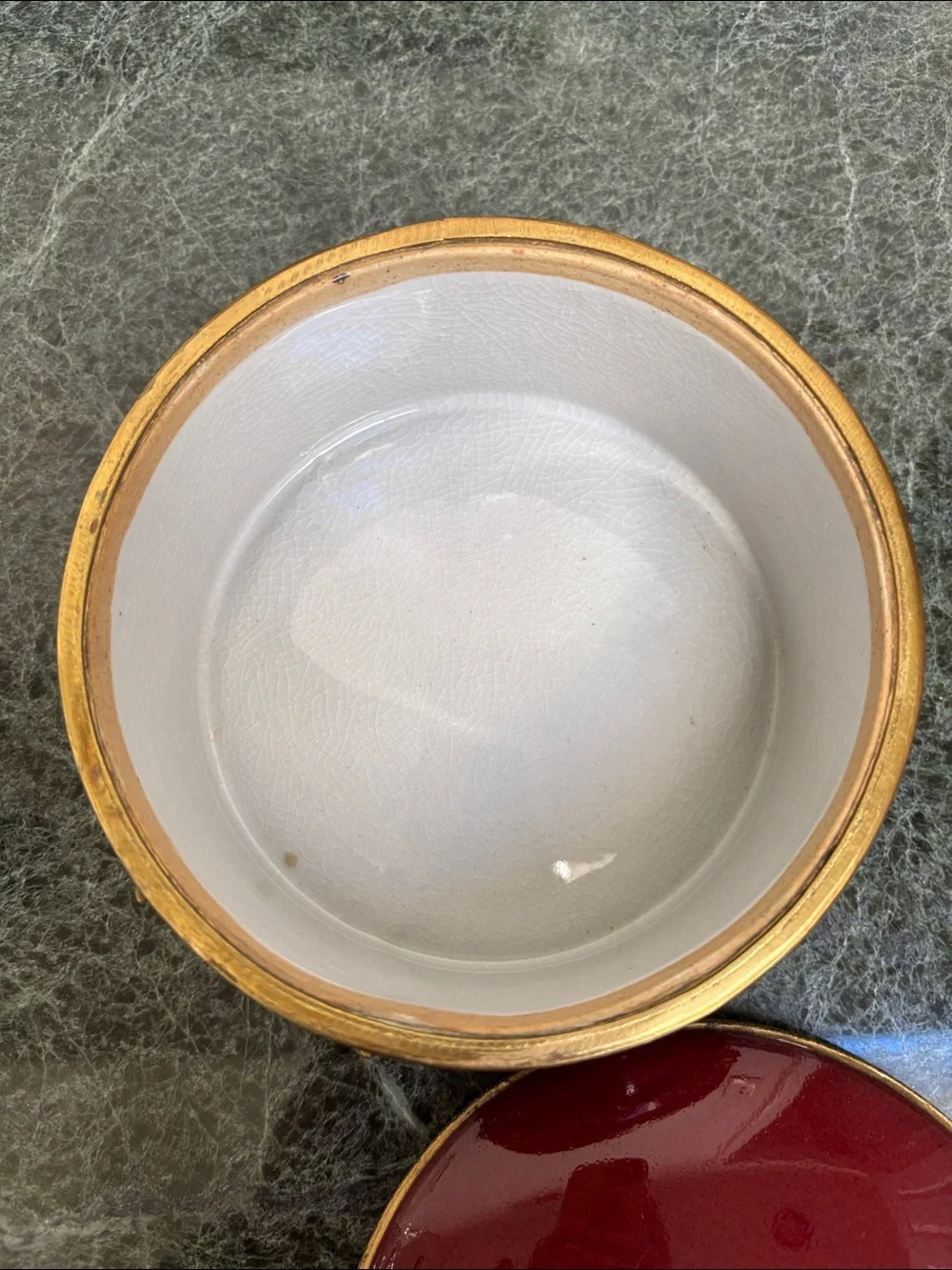 vintage porcelain trinket box with an ornate brass rim